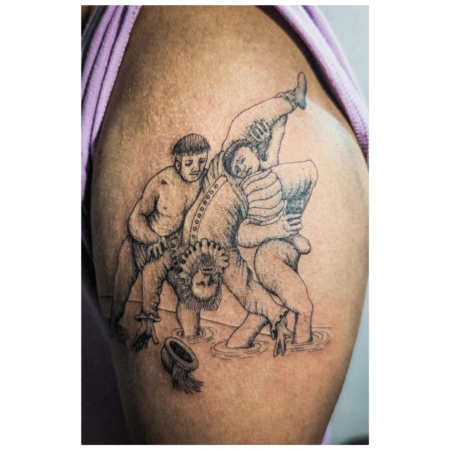 Photo of person's arm with a tattoo depicting the drowning of Diego Salcedo by Tainos.