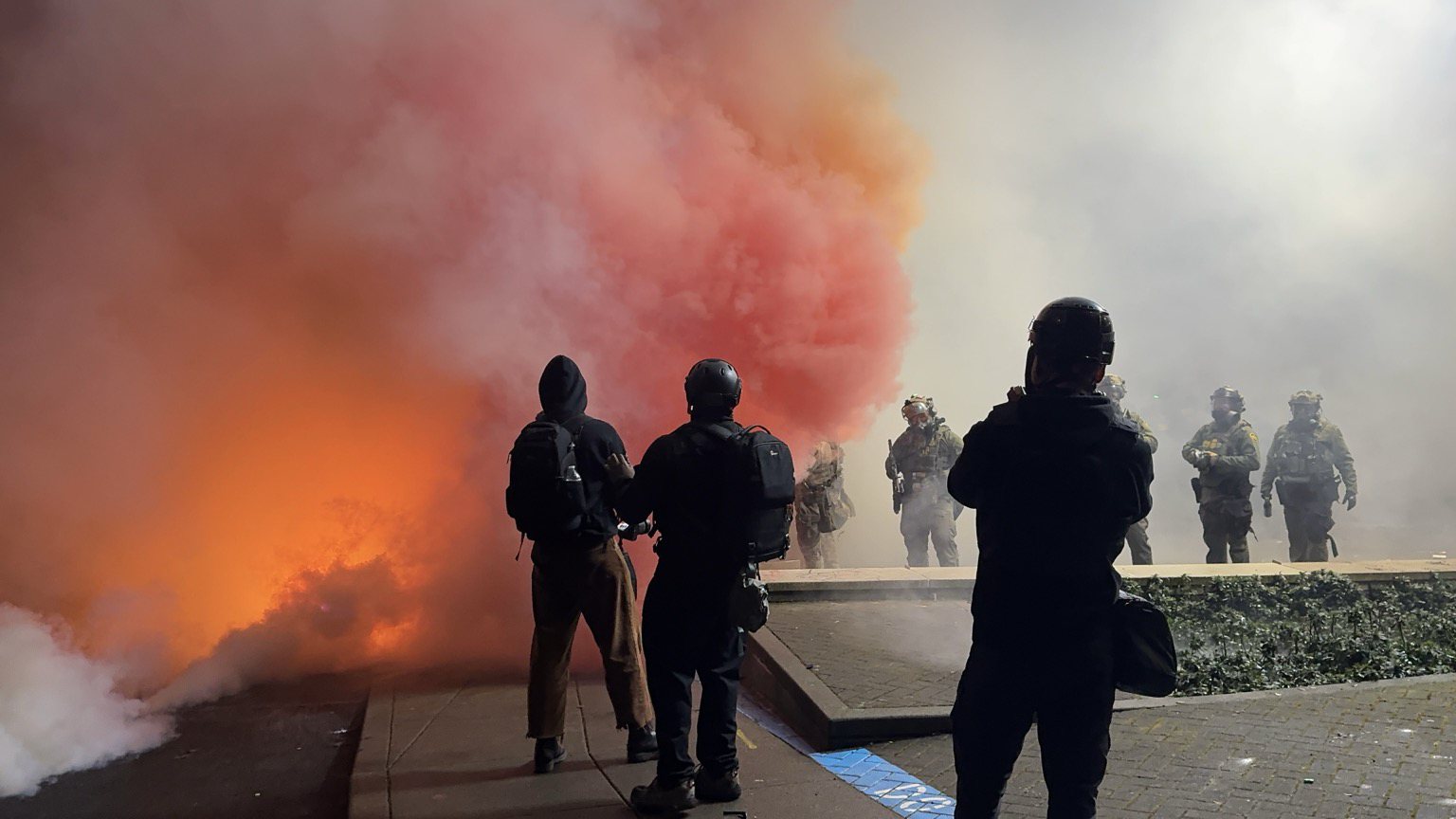 Heavy teargas and colored smoke. Thick clouds of gas