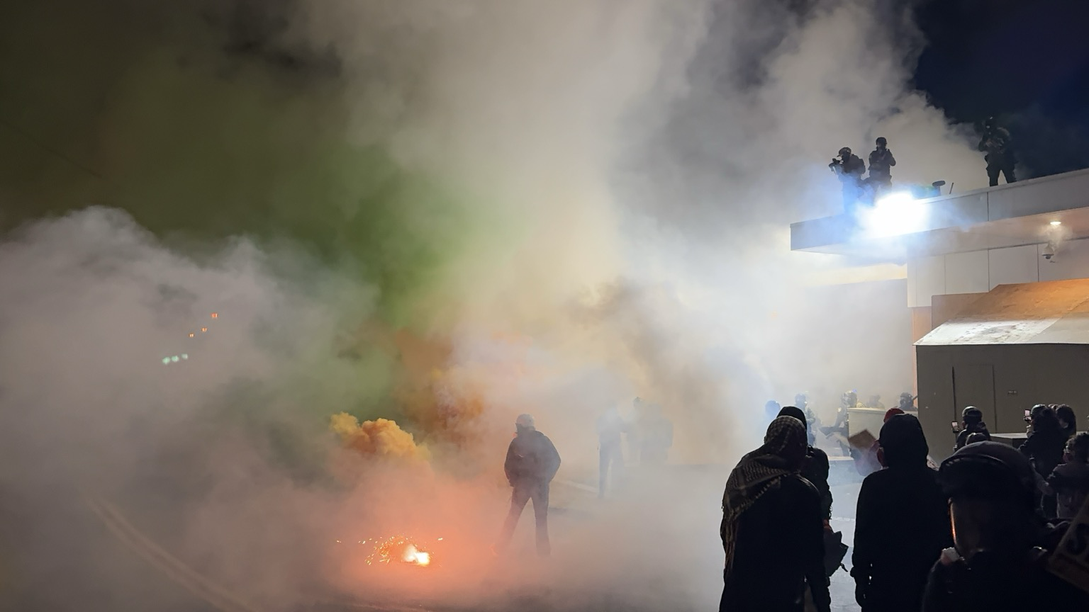 Heavy teargas and colored smoke. Thick clouds of gas