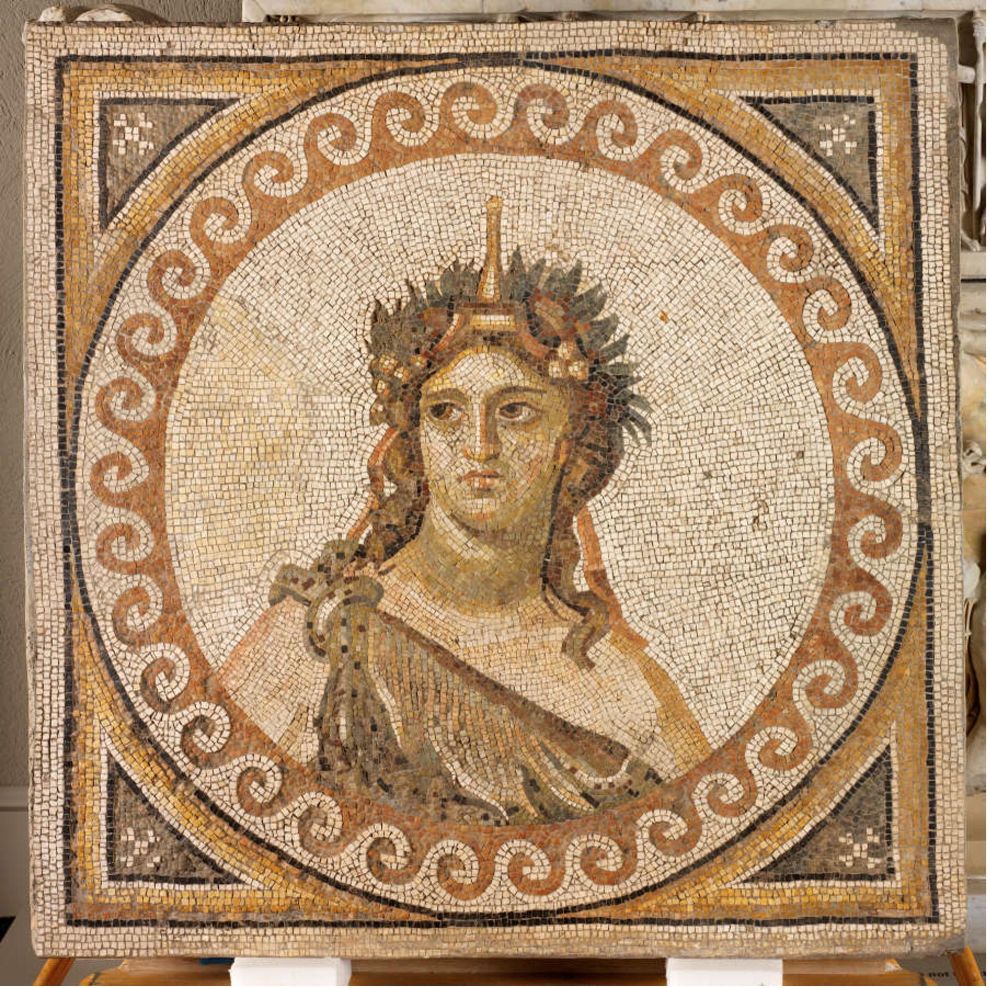 This mosaic medallion depicts Dionysus in his distinctive wreath of fruits and garb that looks like a leopard skin. The facial expression registers something akin to dissatisfaction.