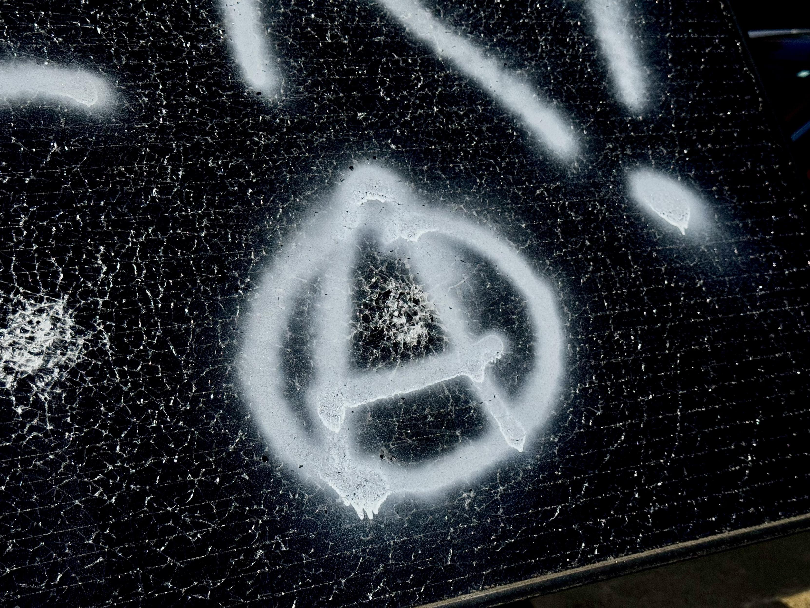 Surveillance solar panel smashed and tagged with a circle A
